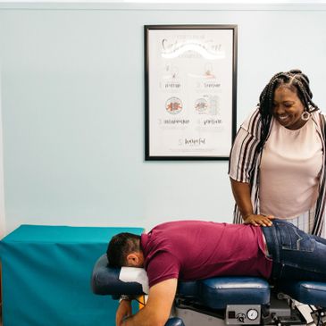 A patient getting adjusted with the flexion and distraction table by our chiropractor.