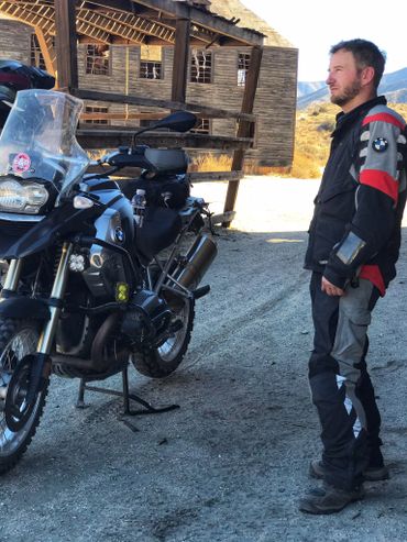 a rider standing near his bike