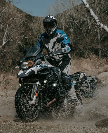 a rider riding a bike through the water