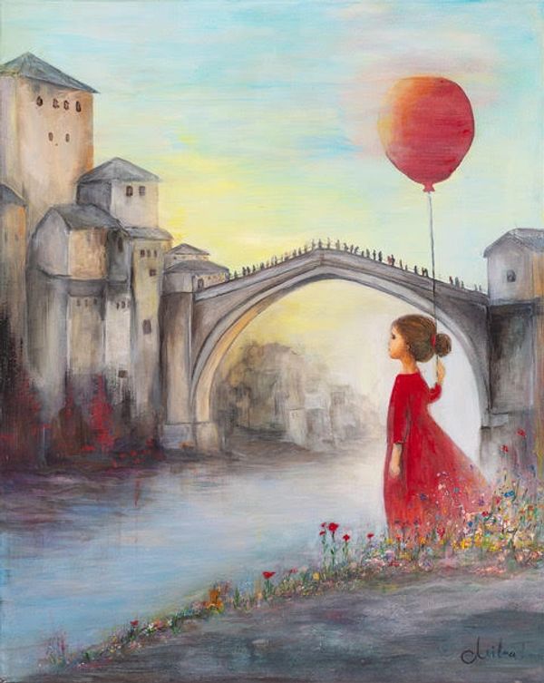 A girl in a red dress holds a red balloon near a stone bridge and old buildings.