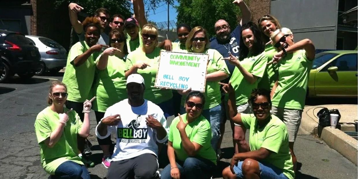 Group photo of volunteers promoting Bell Boy Recycling community involvement.