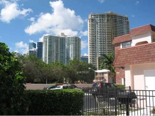 Urban residential area with tall buildings and clear blue sky.