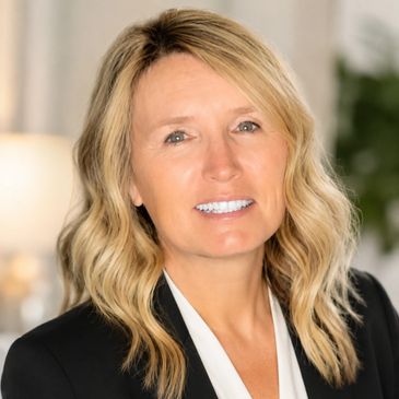 Professional woman with blonde hair smiling.