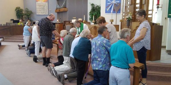 a group of people praying in a church