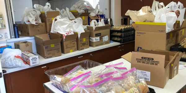 a counter with boxes of food and bags of food