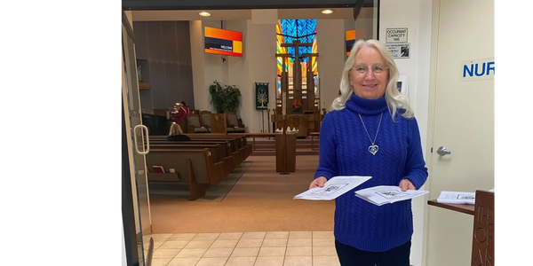 a woman holding a piece of paper in her hands