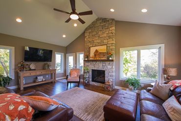 Great room addition with gas fireplace with custom stone facade and floating mantle
