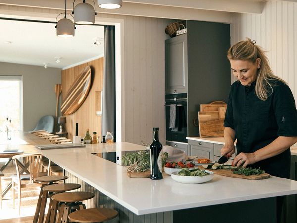 Woman preparing food in a modern kitchen.