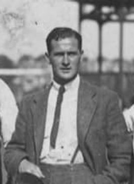 Black and white photo of a man in a suit and tie.
