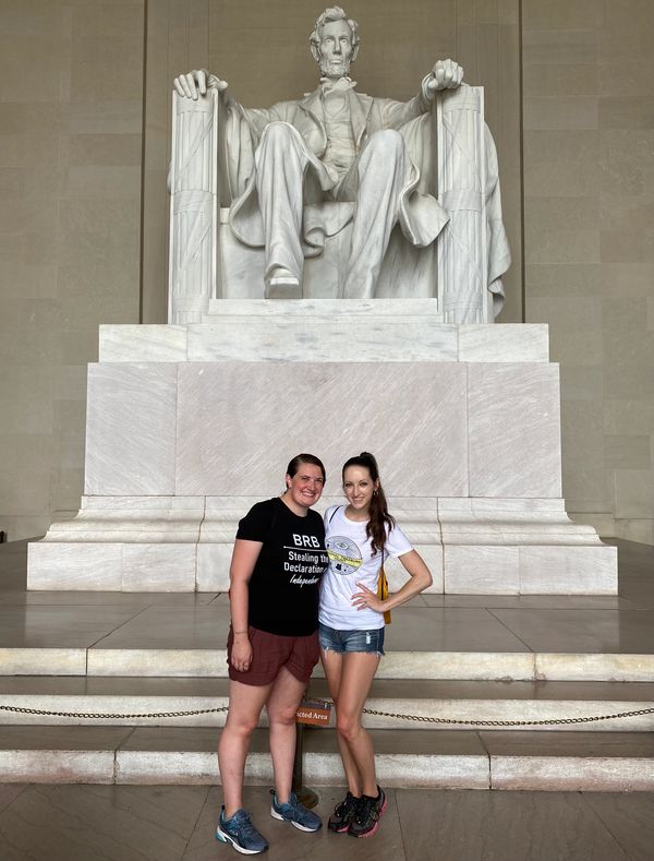 Emily and Aubrey wearing NTH merch in front of the Lincoln Memorial.