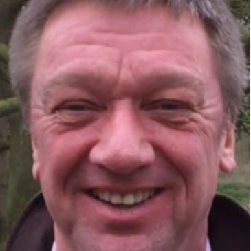 Smiling middle-aged man outdoors.