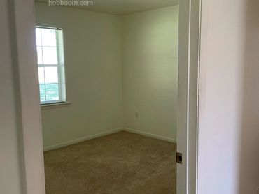 Looking through a doorway into an empty bedroom