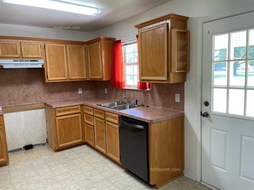 View of a kitchen missing an electric range.