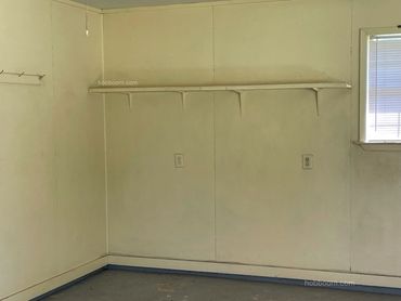 Image of a wall with hooks and shelving.