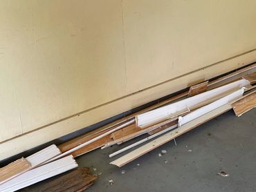 A view of the garage baseboards and floor with other baseboards.