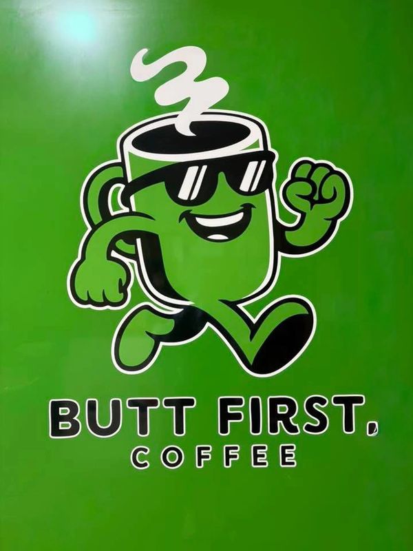 GREEN IMAGE WITH A LARGE ANIMATED CHARACTER COFFEE CUP WITH ARMS AND LEGS IN JOGGING MOTION WEARING
