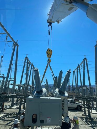 45 ton truck crane placing circuit breaker in electrical substation.