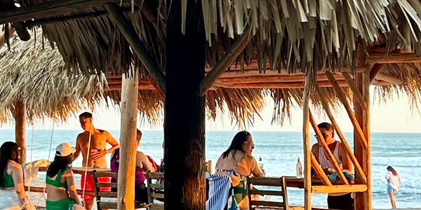 Hotel Tranquilo guests enjoying private beach area and beachfront rancho overlooking pacific ocean