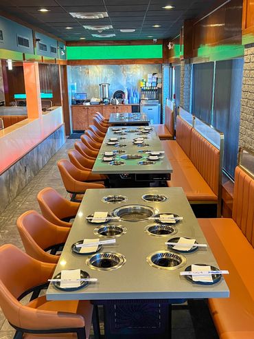 set tables with hot pots and korean bbq