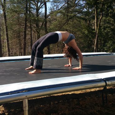 trampoline yoga wheel pose