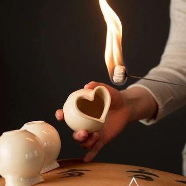 Fire Cupping Performed on woman's back with heart-shaped cups.