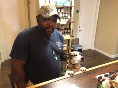 Disabled Army Ranger with service dog standing at clinic front desk.