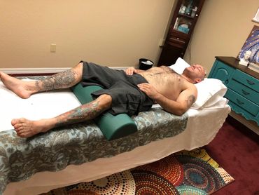 Man resting on a treatment table with acupuncture neeles at East Lake Acupuncture in St. Cloud, FL.