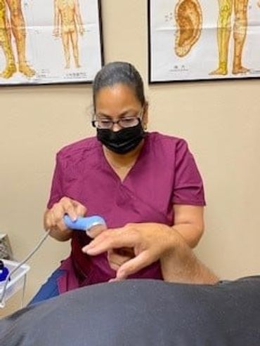 Nurse performing an ultrasound on a man's hand