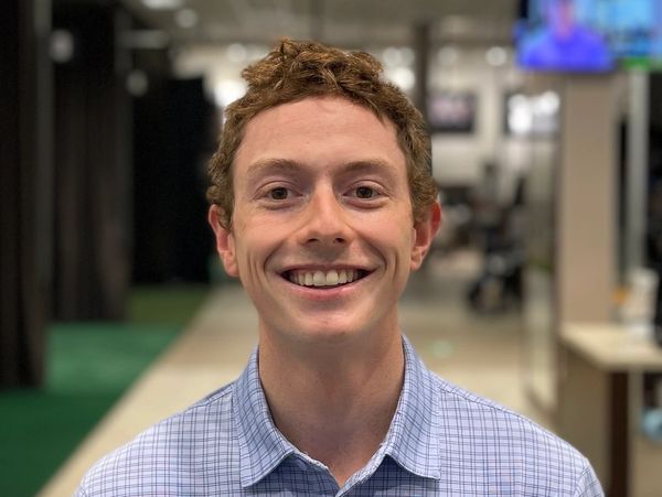 Image of Coach Sam Roy. Smiling headshot image.