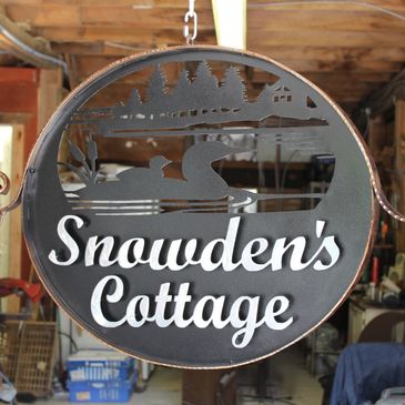 Plasma cut and powder coated cottage sign with wrought iron border