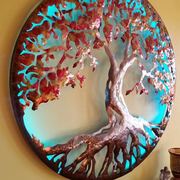 46" Plasma cut tree of life. Hammered for depth, dyed, powder coated and backlit with led lighting. 