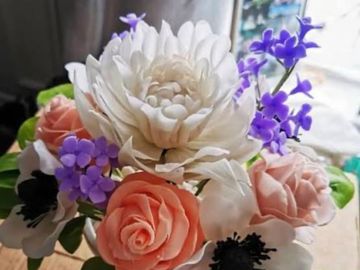 A bouquet of white, pink, and purple flowers.