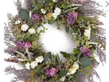 Decorative floral wreath with purple and white flowers.