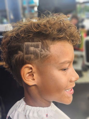 Kids haircut with a custom shaved hair design at Daniel’s Barber Shop