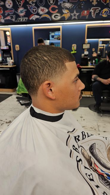 Men’s fade haircut with a clean neckline and blended sides