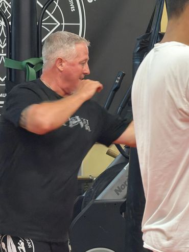 Man practicing martial arts inside a gym.