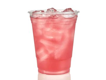 Clear plastic cup filled with pink iced beverage on a white background.