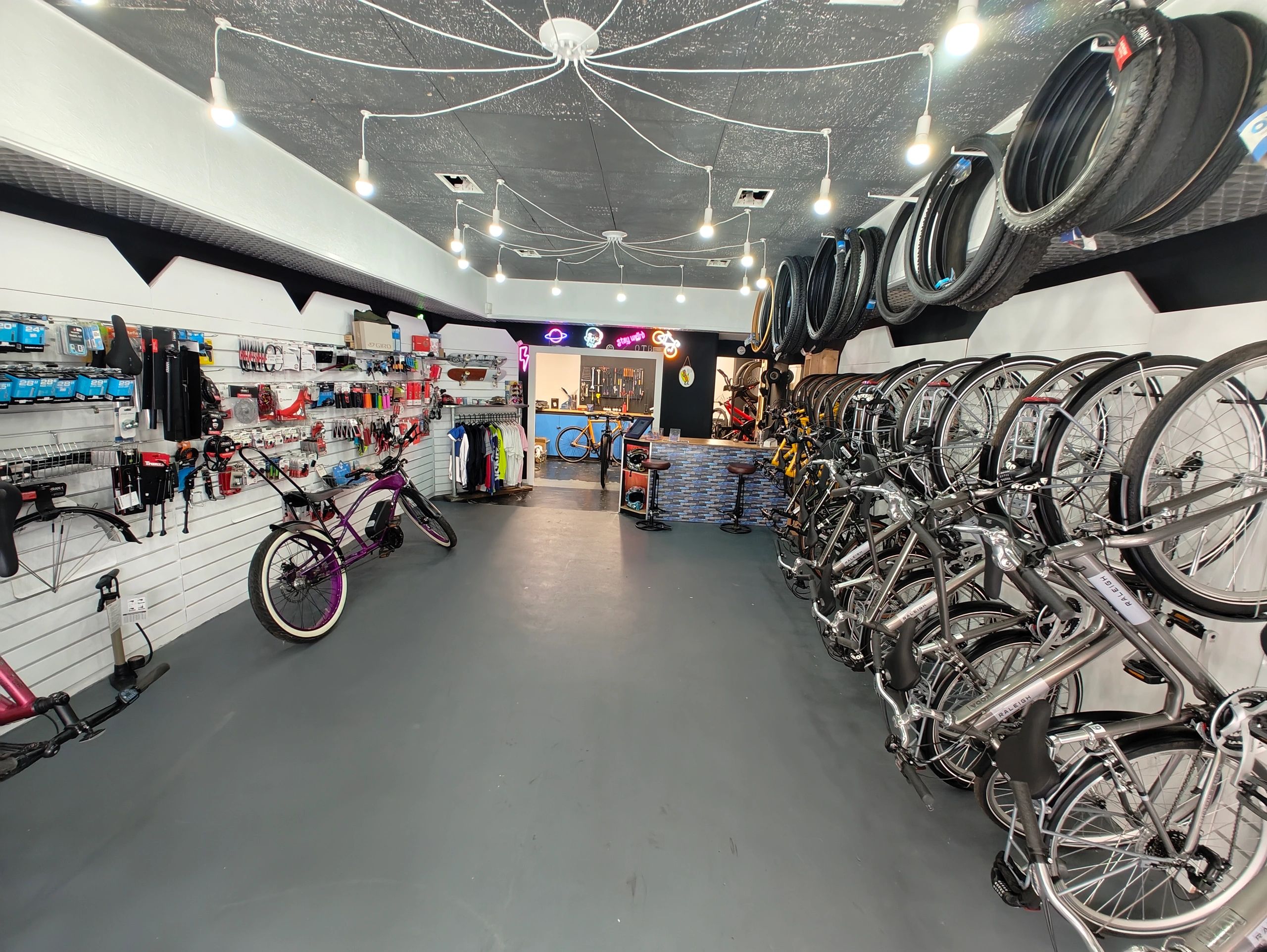 Modern bike shop with bicycles, tires, and accessories neatly displayed.