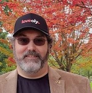 Olympia Computer CEO Erik Johnson wearing Love Oly cap.