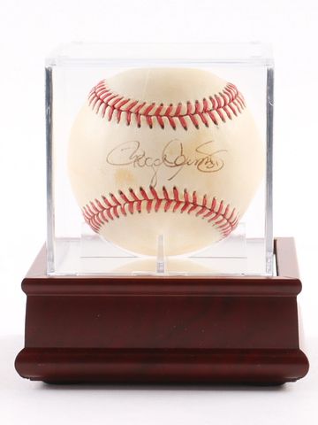 Signed baseball in a display case on a wooden base.