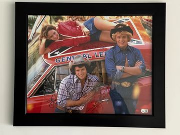 Framed photo of The Dukes of Hazzard cast with car.