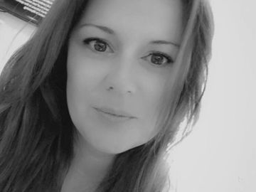 Black and white close-up portrait of a woman with long hair.