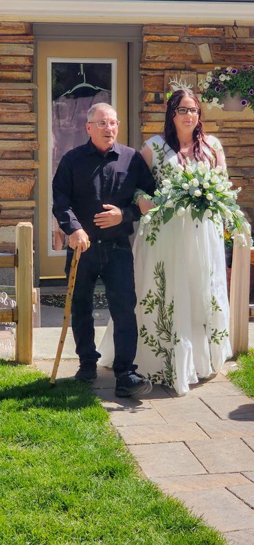 A father takes his daughter's arm and walks her down the aisle to marry the man of her dreams.