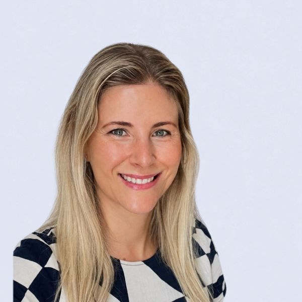 Bree Parker of Parker Mortgage & Finance smiling, with long blonde hair and a navy and white pattern