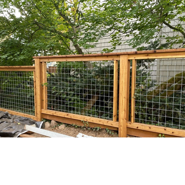 Wood and wire mesh fence enclosing a green garden area.