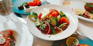five plates with food and a glass on the table