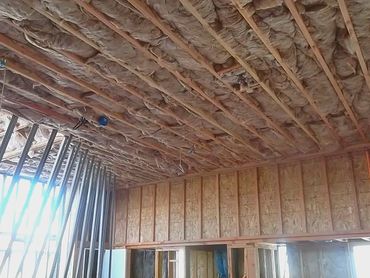 Ceiling insulation installed in a building under construction.