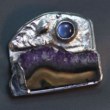 Sterling silver brooch featuring amethyst slice and moonstone