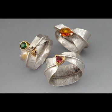 Fold formed silver rings with various faceted stones