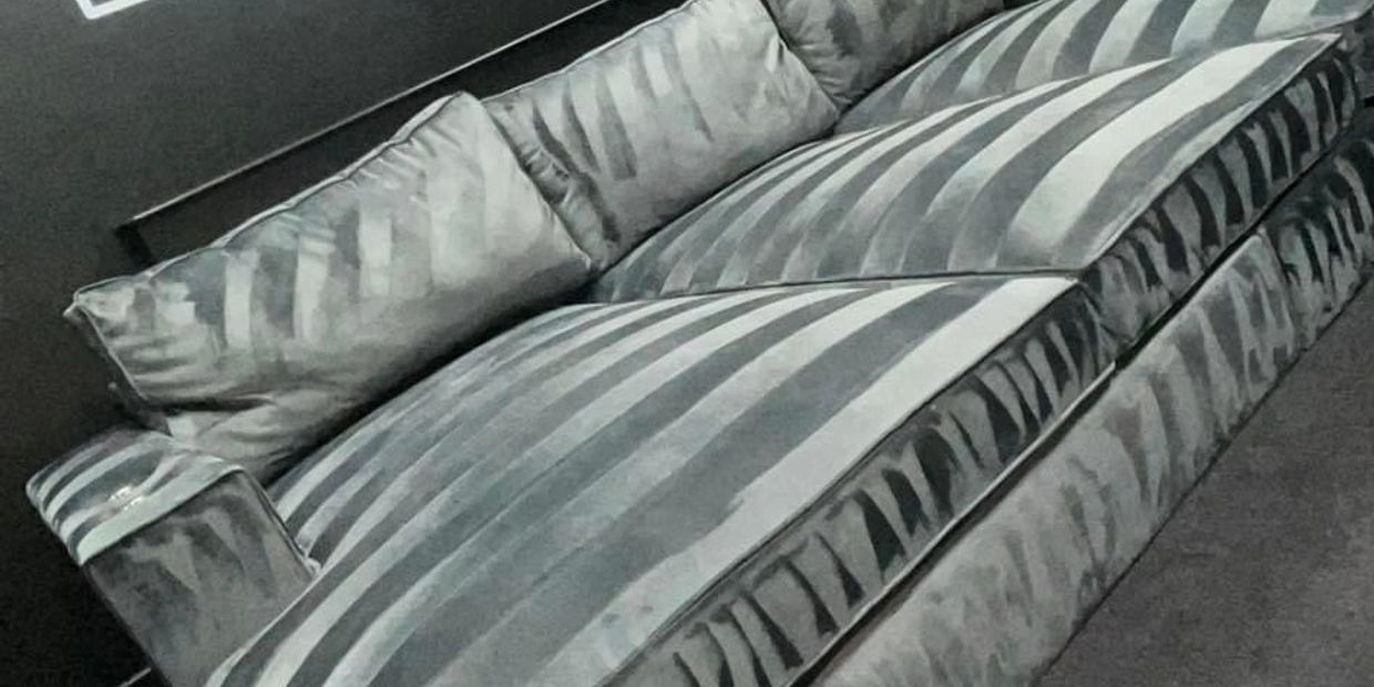Luxurious striped velvet couch with plush cushions in a modern living room.